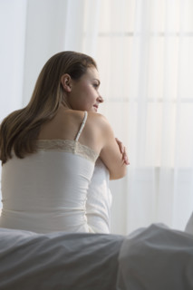Woman relaxing on her bed.