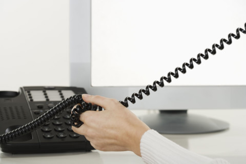 Woman talking on telephone.
