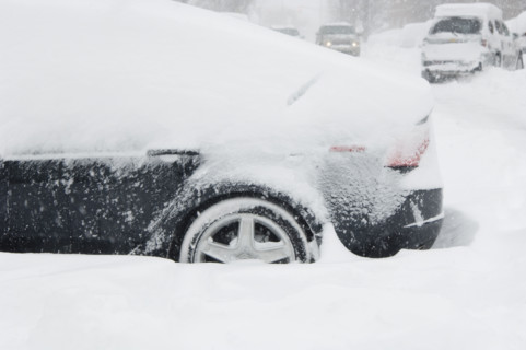 Car buried in snow in winter.