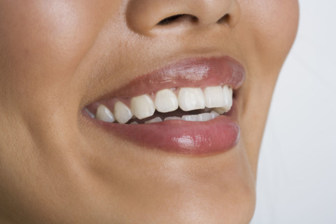 Close up of woman smiling.