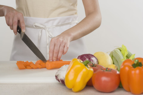 Woman chopping vegetables.