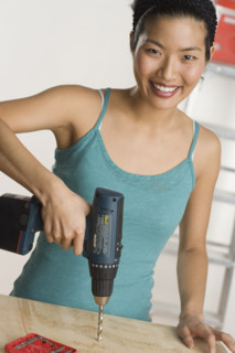 Portrait of woman doing home repairs.