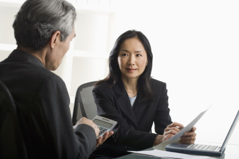 Asian businesswoman talking to businessman.