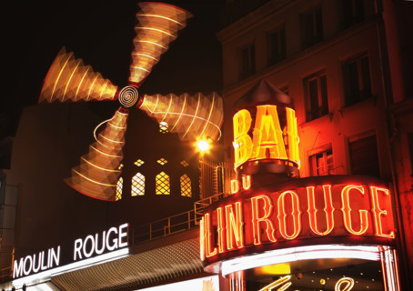 Neon signs in urban scene, Moulin Rouge, Paris, France.