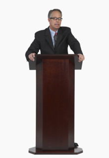 Businessman speaking at podium.