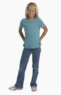 Studio shot of girl with hands in back pockets.