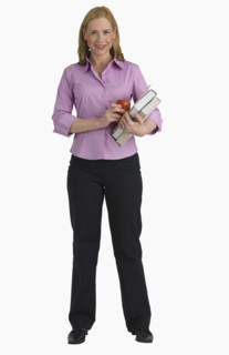 Studio shot of female teacher holding books.