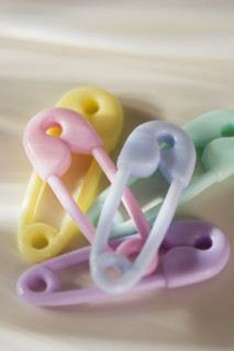 Close up of plastic diaper pins.