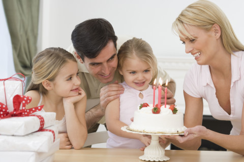 Girl celebrating birthday with family.