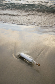 Message in bottle on beach.