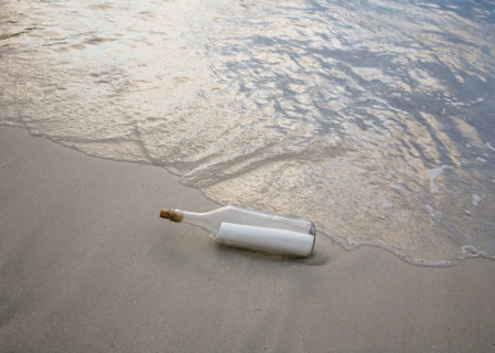 Message in bottle on beach.