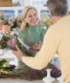 Female florist helping customer.