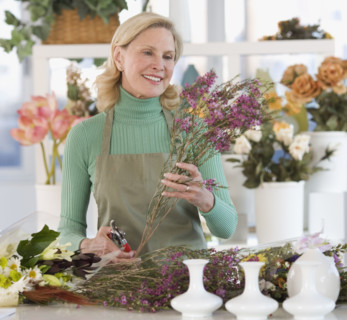 Female florist cutting flowers.