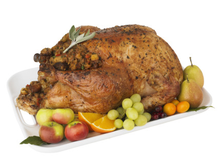 Roasted turkey and fruit on platter.