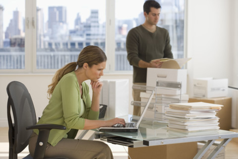 Businesspeople setting up new office.