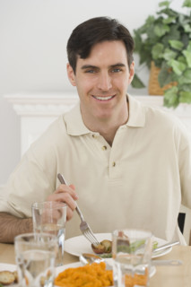 Portrait of man at dinner table.