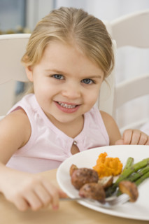 Portrait of girl at dinner table.