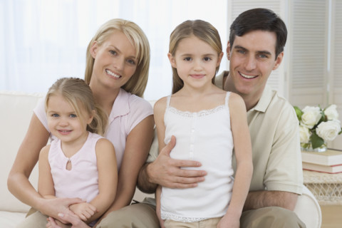 Portrait of family on sofa.
