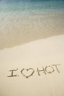 I Love Hot written in sand.
