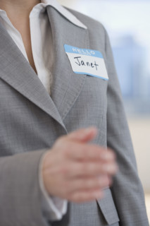 Businesswoman wearing Hello My Name Is sticker.