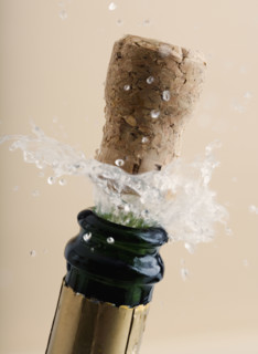 Close up of champagne cork popping.