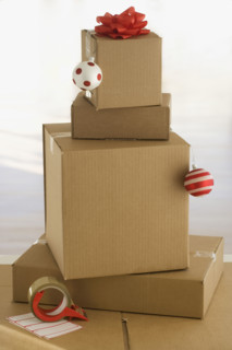 Shipping boxes with gift bow and Christmas ornaments.