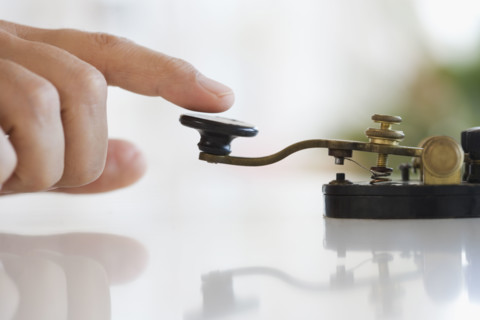 Close up of man using telegraph.
