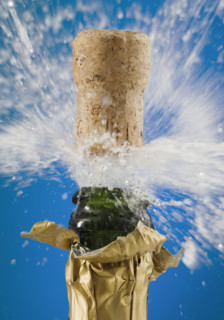 Close up of champagne cork popping.