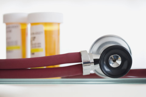 Close up of stethoscope and medication.