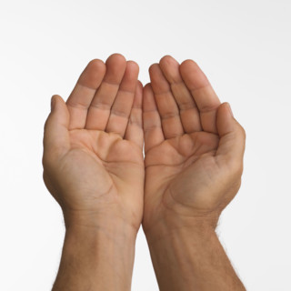 Close up studio shot of man's cupped hands.
