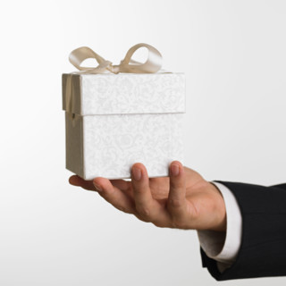 Close up studio shot of man holding gift.