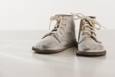 Close up of old fashioned baby shoes.