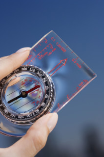 Close up of woman holding compass.