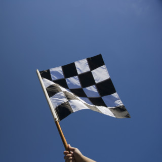 Checkered flag with blue sky.