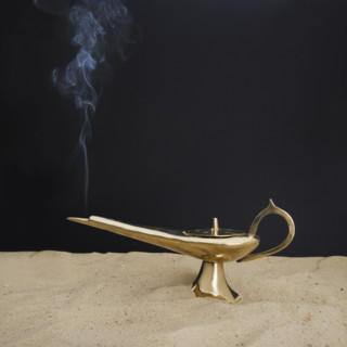 Close up of incense burner on sand.