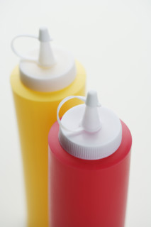Close up of ketchup and mustard bottles.