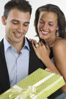 Woman giving man gift.