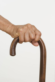 Close up of senior's hand on cane.