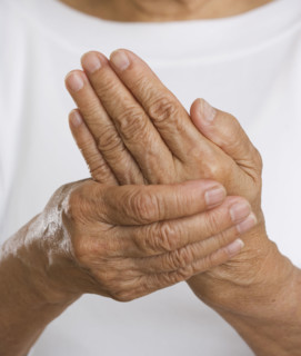 Close up of senior rubbing hands together.