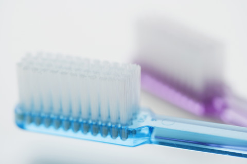 Close up of toothbrushes.