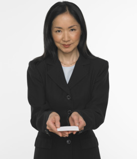 Asian businesswoman offering business card.