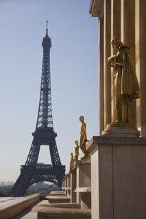 Golden statues with Eiffel Tower in background.