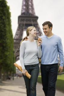 Couple walking with Eiffel Tower in background.