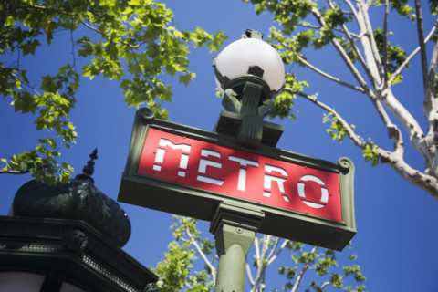 Low angle view of Metro sign on lamp post.