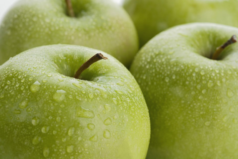 Close up of apples with water droplets.