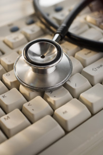 Close up of stethoscope on computer keyboard.