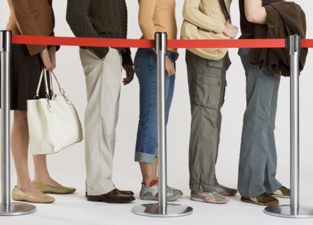 Group of people standing in line.