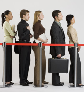 Group of people standing in line.