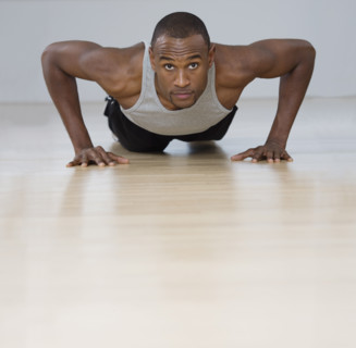 Man doing pushups indoors.