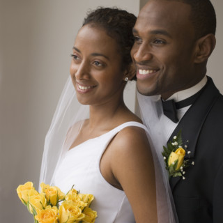Close up of bride and groom smiling.